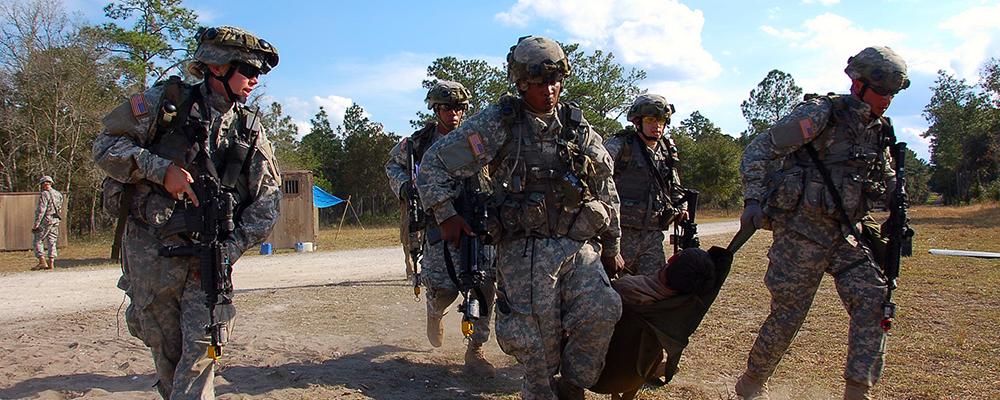 Army_Guardsmen carrying injured man Thumbnail
