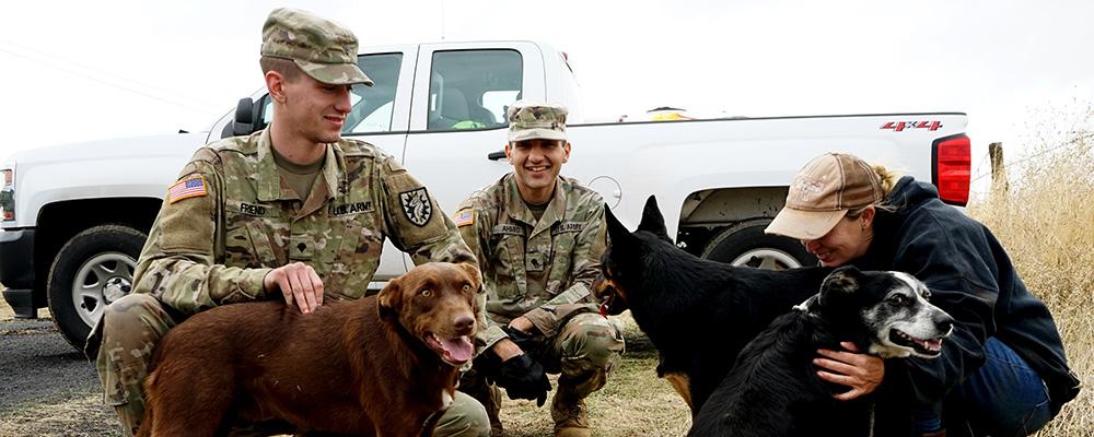 Army Guardsmen with dogs and civilian